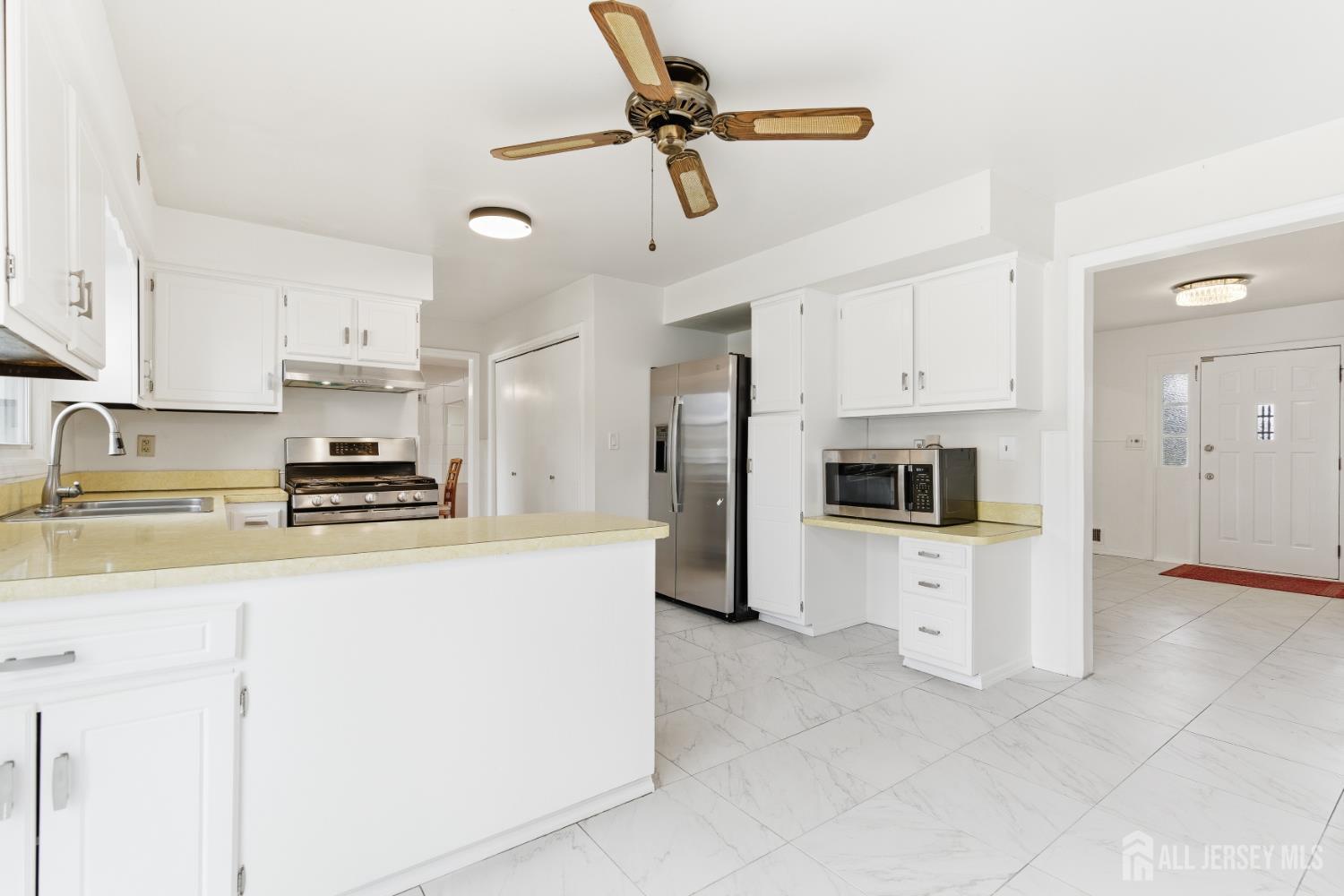 7 Oberlin Court Edison, NJ 08820 - Photo 11 of 40 a kitchen with stainless steel appliances granite countertop a refrigerator a stove a sink a stove with white cabinets