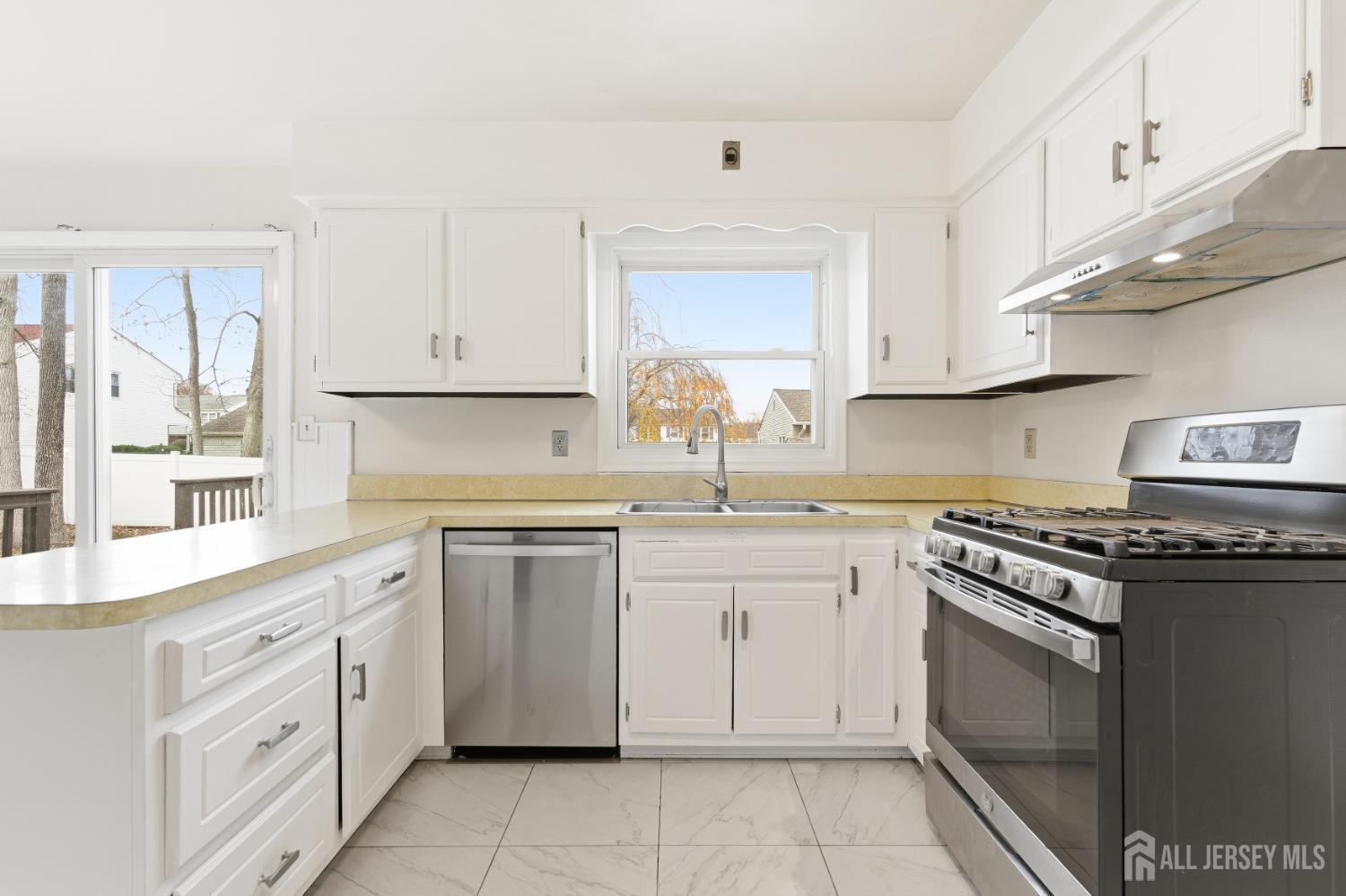 7 Oberlin Court Edison, NJ 08820 - Photo 12 of 40 a kitchen with cabinets appliances a sink and a counter top space
