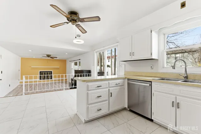 a kitchen with cabinets appliances cabinets and a window