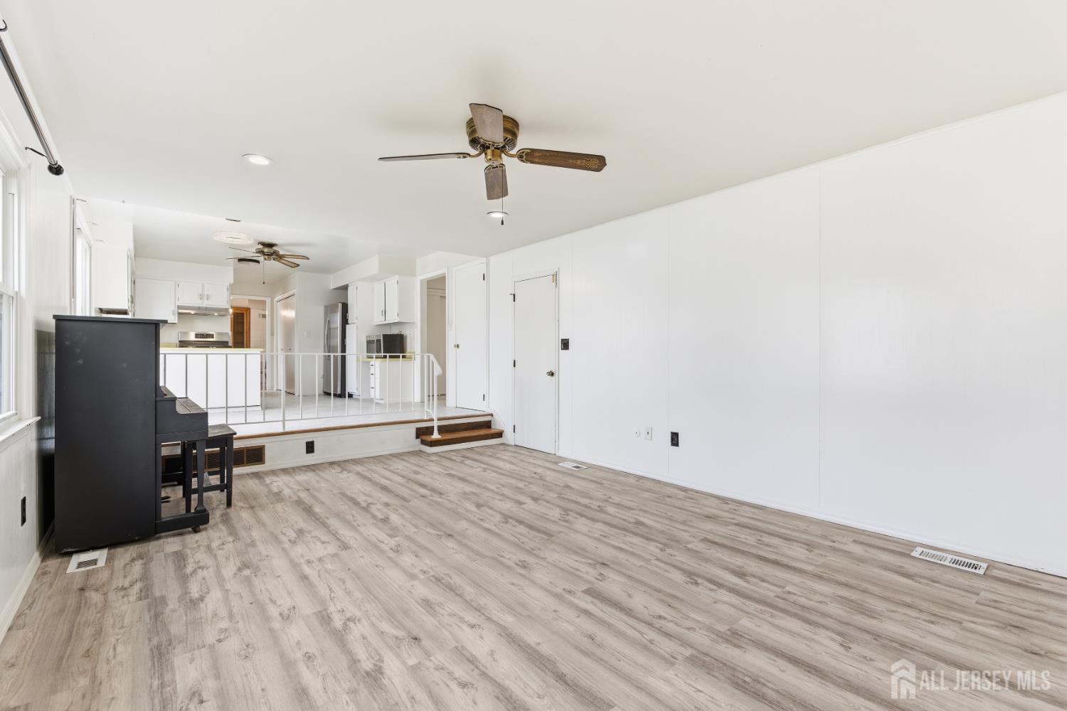 7 Oberlin Court Edison, NJ 08820 - Photo 16 of 40 an empty room with wooden floor and windows