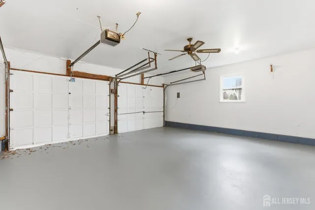 a view of a room with window and ceiling fan