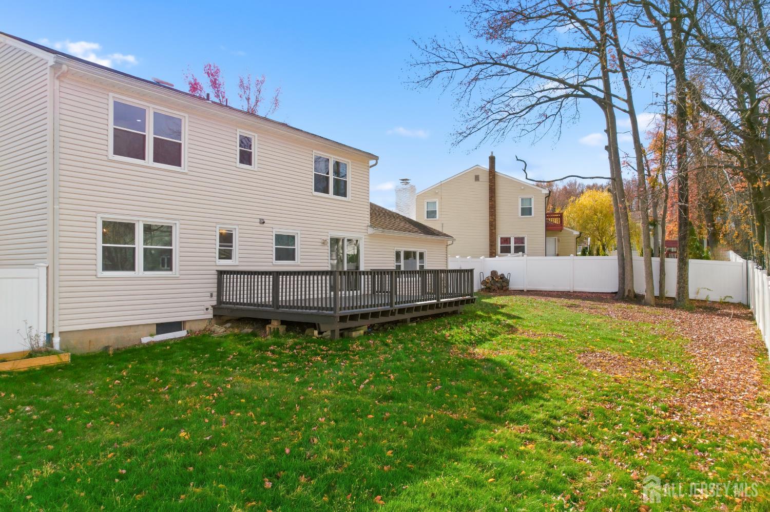 7 Oberlin Court Edison, NJ 08820 - Photo 34 of 40 a view of a house with wooden fence and a yard