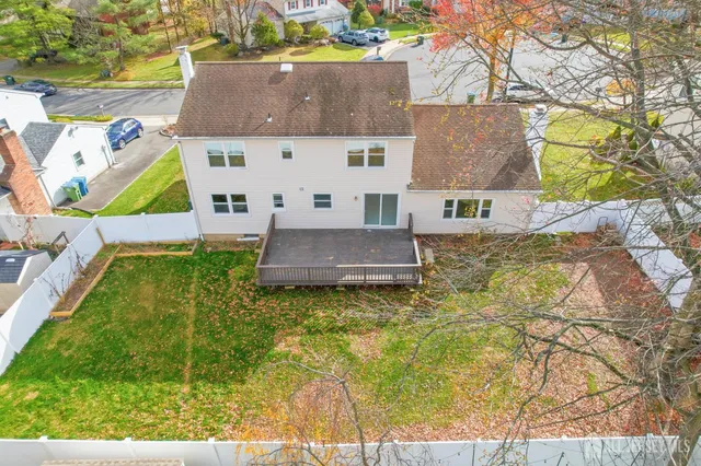an aerial view of residential houses with outdoor space and swimming pool
