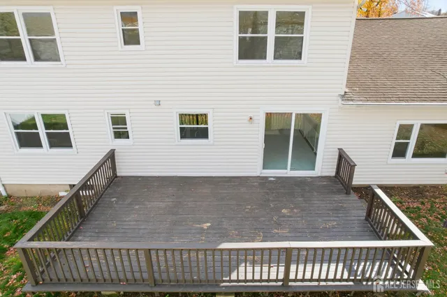 a view of a house with wooden deck