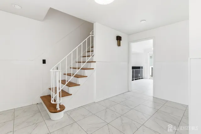 a view of entryway with hall and stairs