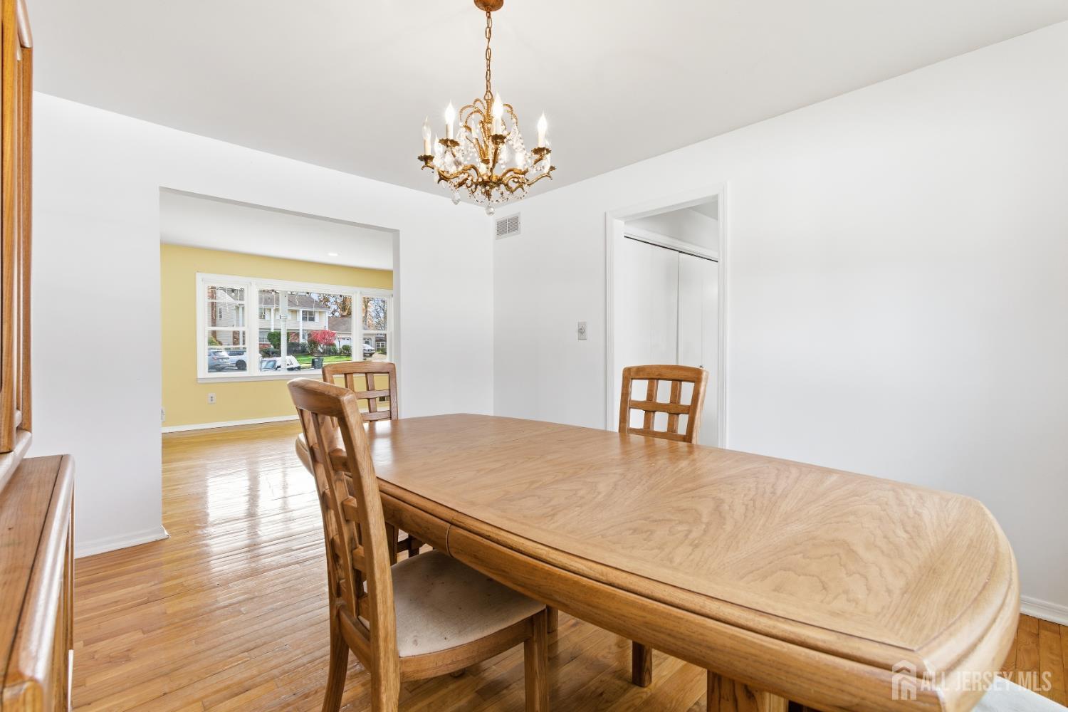 7 Oberlin Court Edison, NJ 08820 - Photo 9 of 40 a view of a dining room with furniture a chandelier and wooden floor
