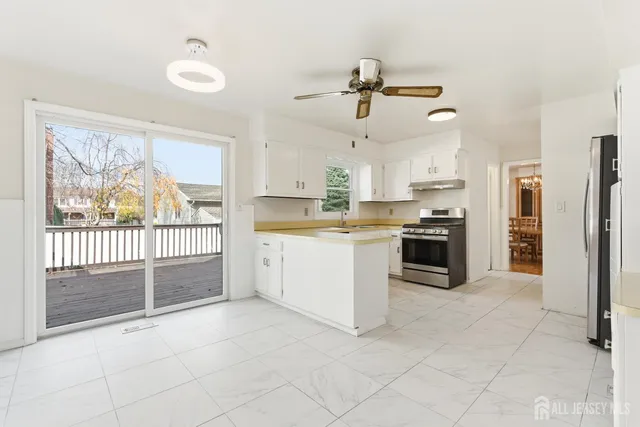 a kitchen with stainless steel appliances a refrigerator sink and cabinets