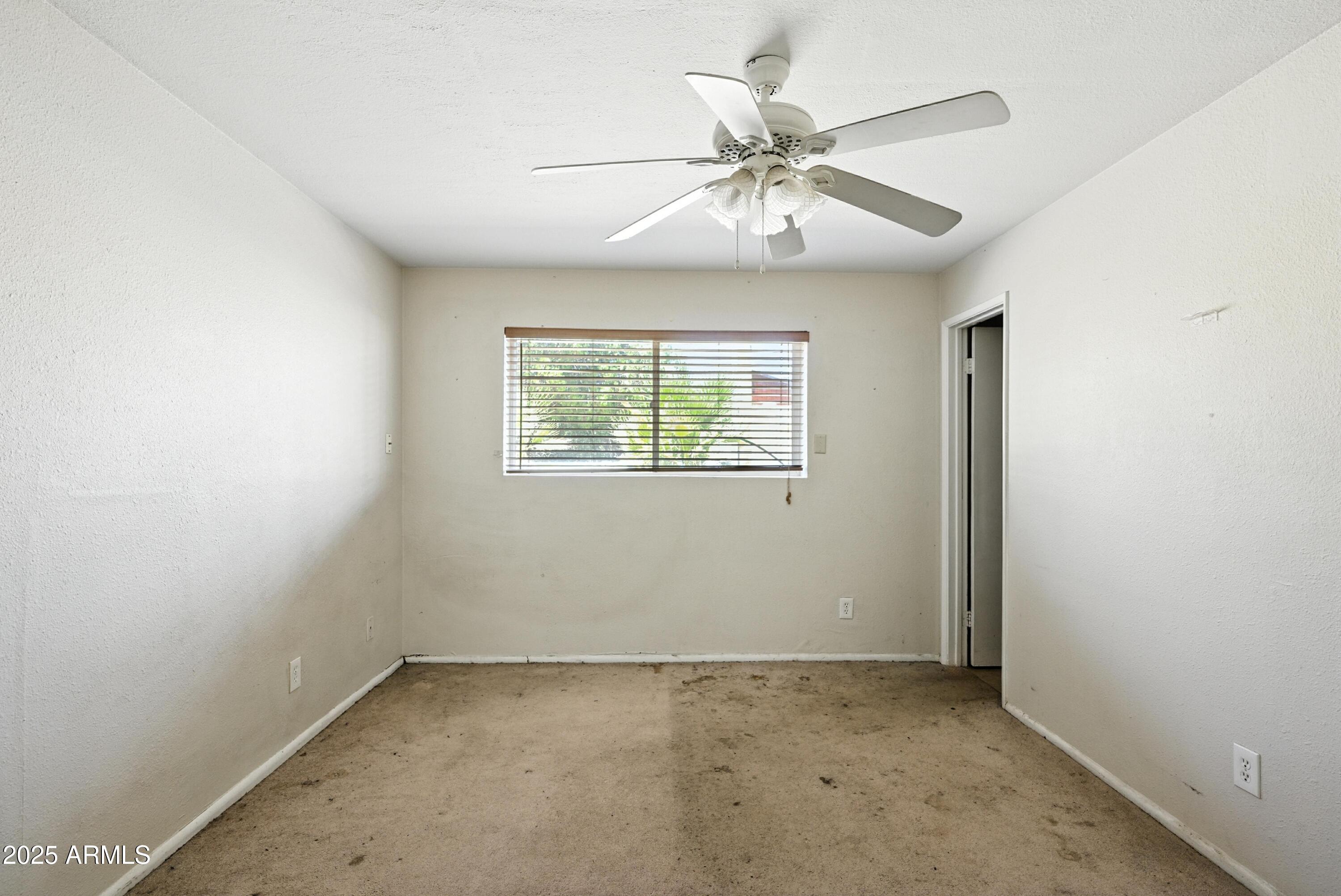 3724 West Bloomfield Road Phoenix, AZ 85029 - Photo 16 of 32 an empty room with windows and fan