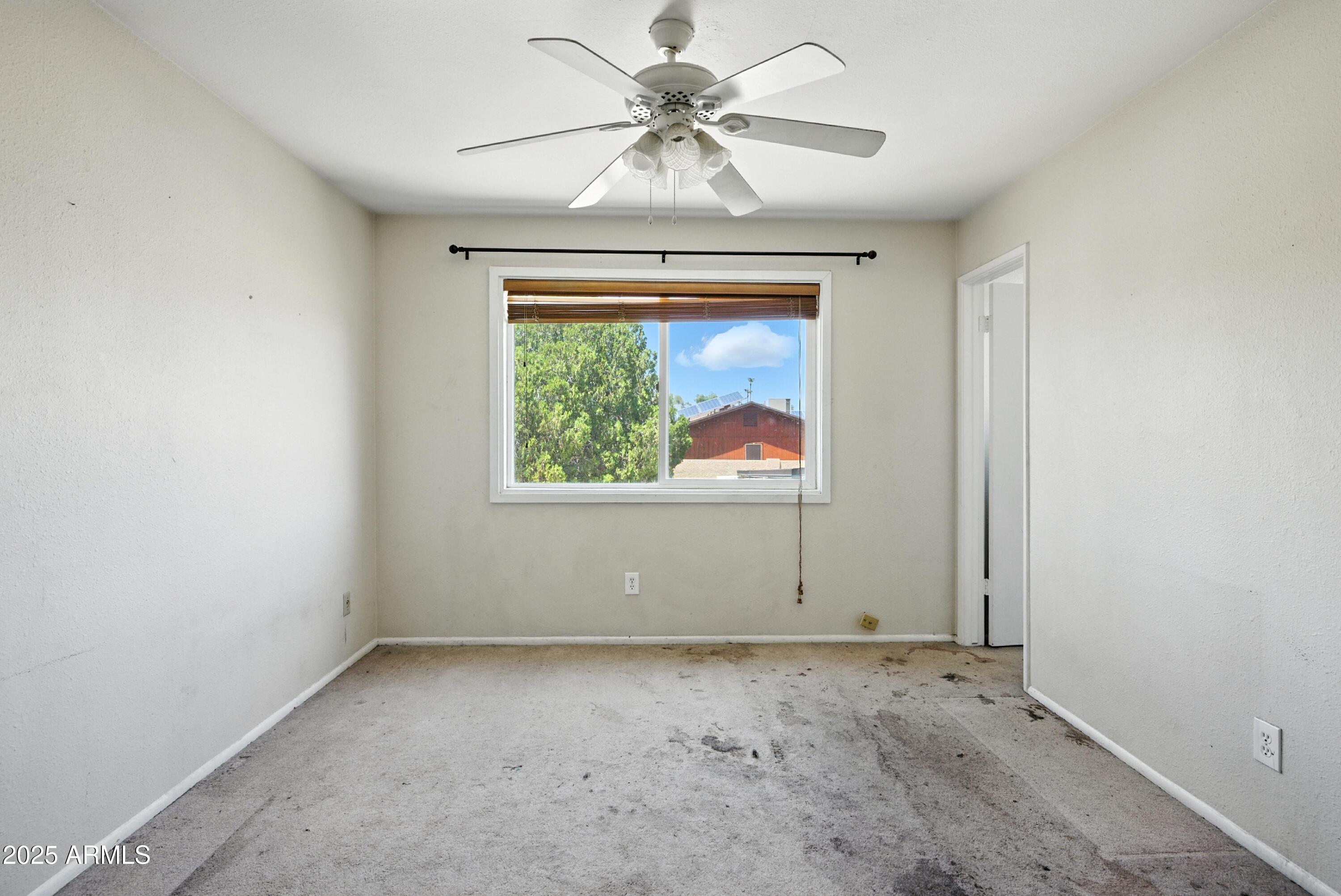 3724 West Bloomfield Road Phoenix, AZ 85029 - Photo 25 of 32 an empty room with windows and fan