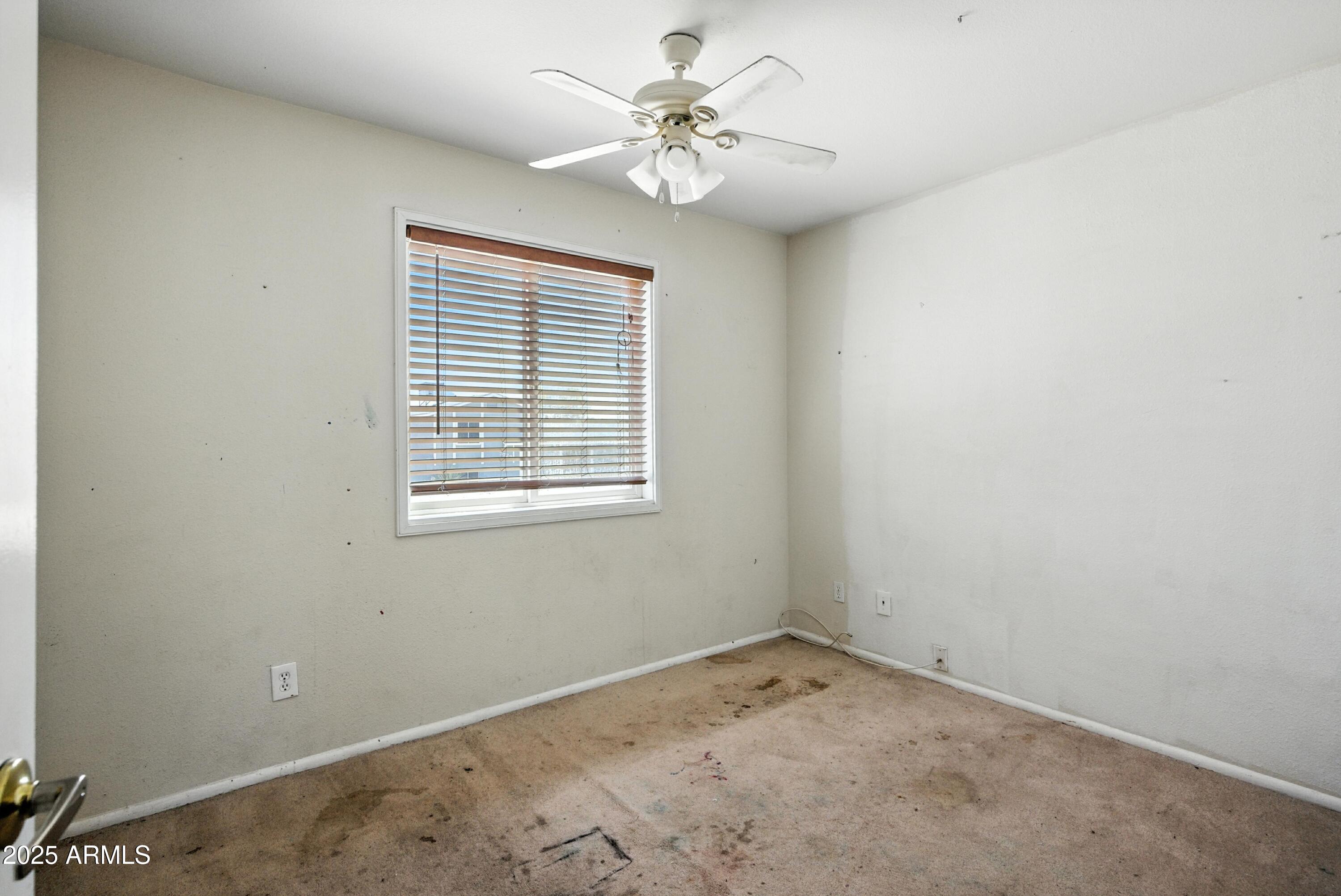 3724 West Bloomfield Road Phoenix, AZ 85029 - Photo 27 of 32 an empty room with a window and a fan