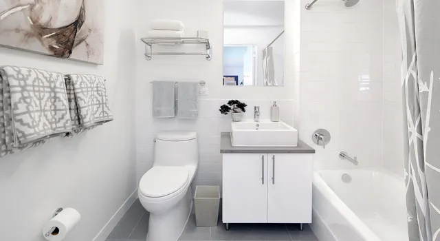 a bathroom with a sink a toilet and bathtub