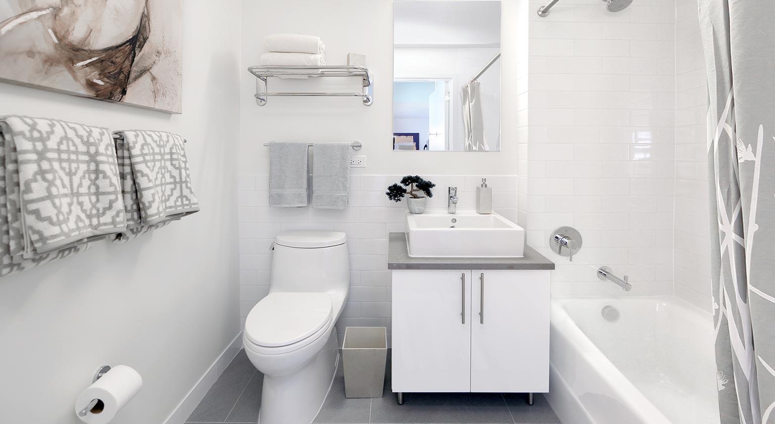 81 Fleet Place, Unit 11M Brooklyn, NY 11201 - Photo 4 of 10 a bathroom with a sink a toilet and bathtub