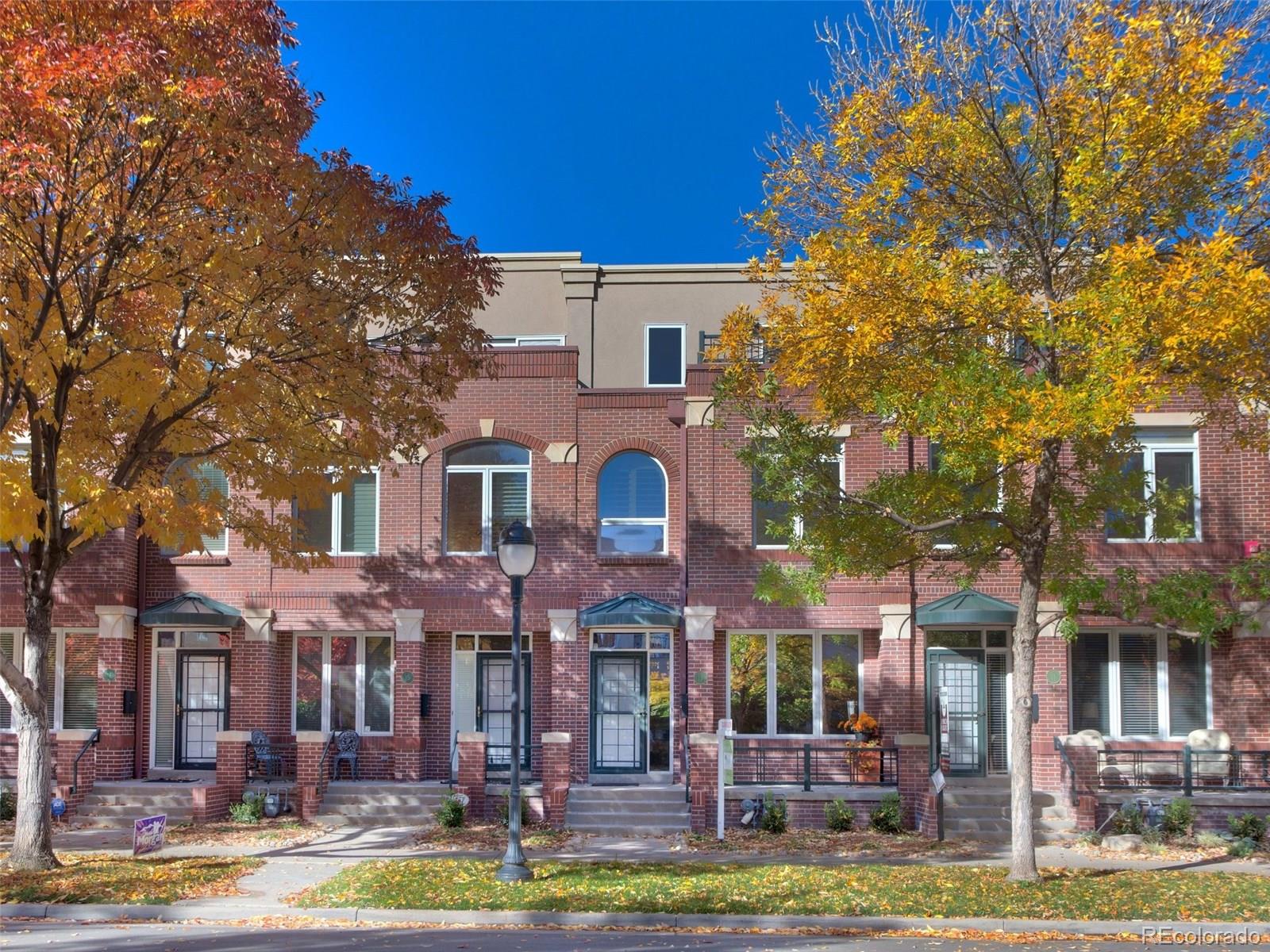 a front view of a building with trees around