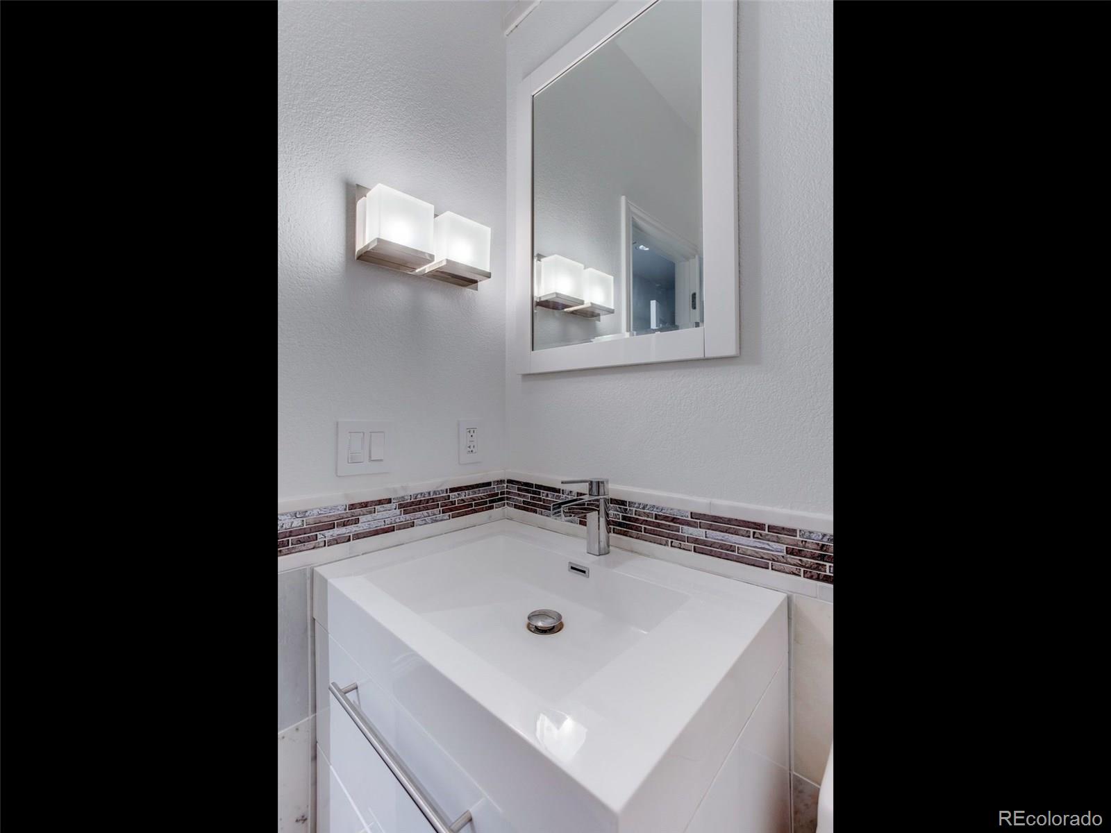 13 South Garfield Street Denver, CO 80209 - Photo 13 of 27 a bathroom with a sink and a mirror