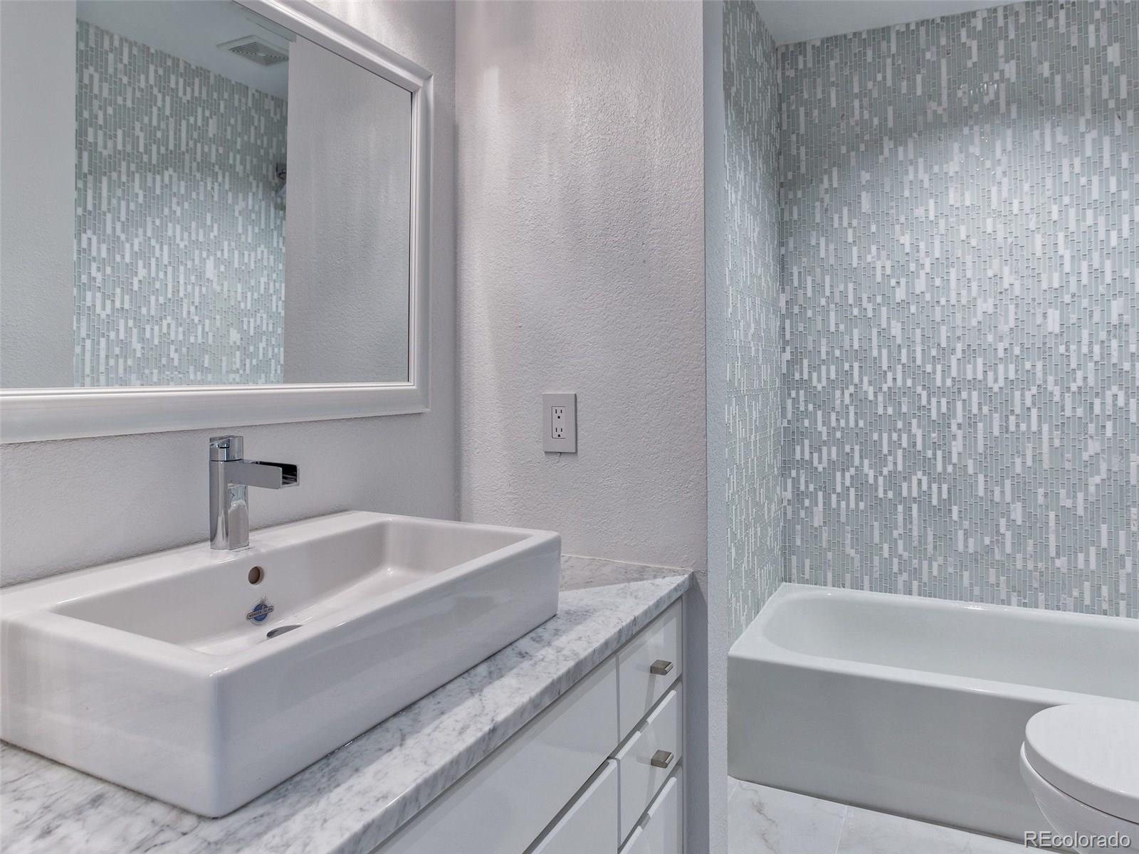 13 South Garfield Street Denver, CO 80209 - Photo 17 of 27 a bathroom with a sink and a bathtub