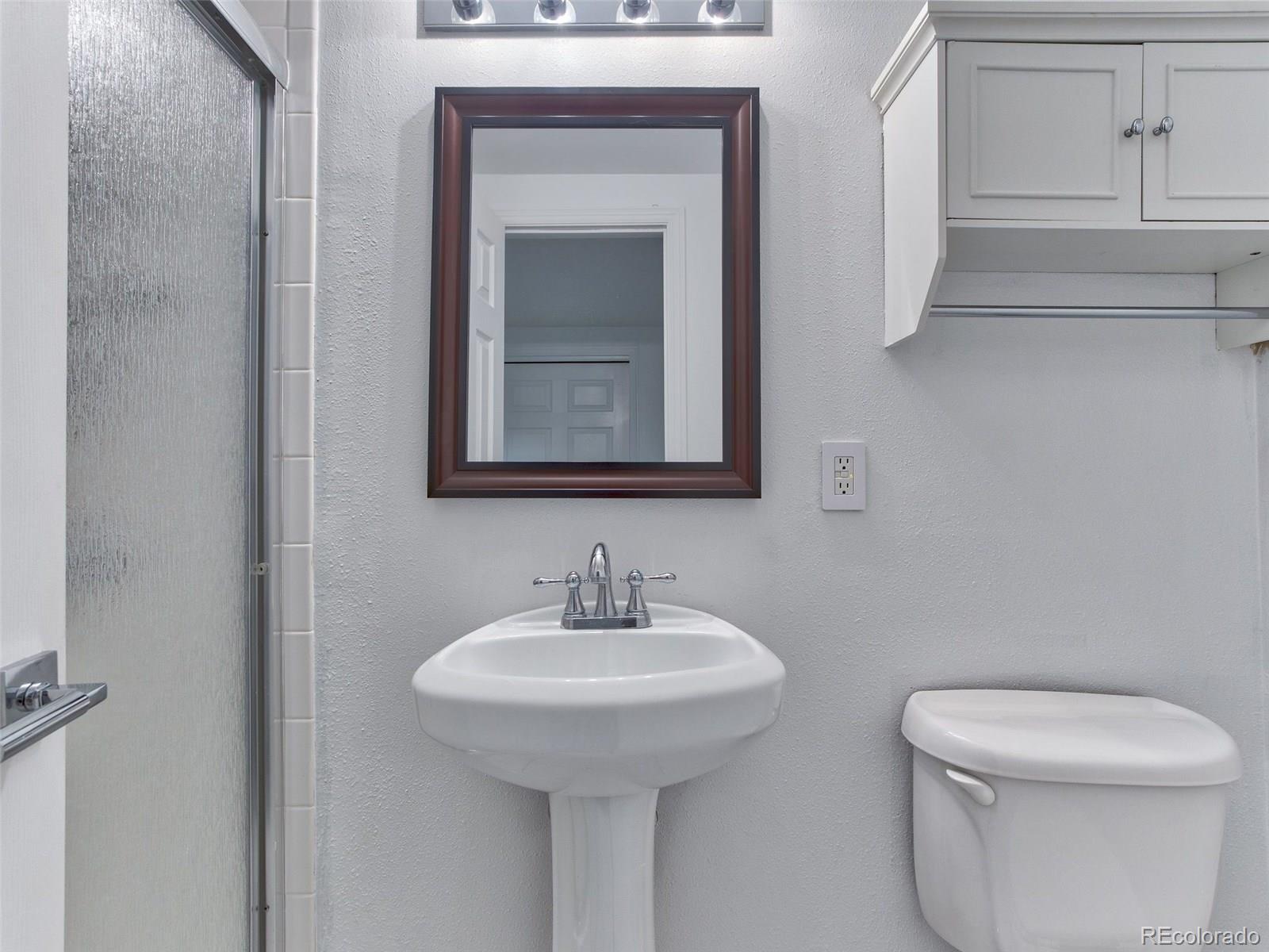 13 South Garfield Street Denver, CO 80209 - Photo 23 of 27 a bathroom with a toilet sink and mirror