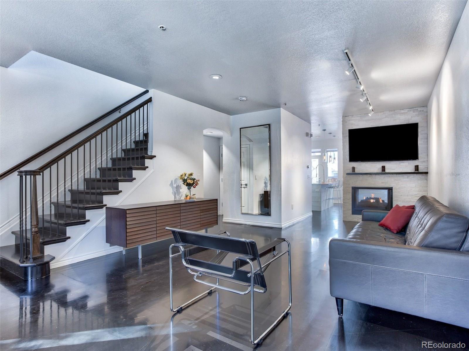 13 South Garfield Street Denver, CO 80209 - Photo 5 of 27 a living room with fireplace furniture and a flat screen tv