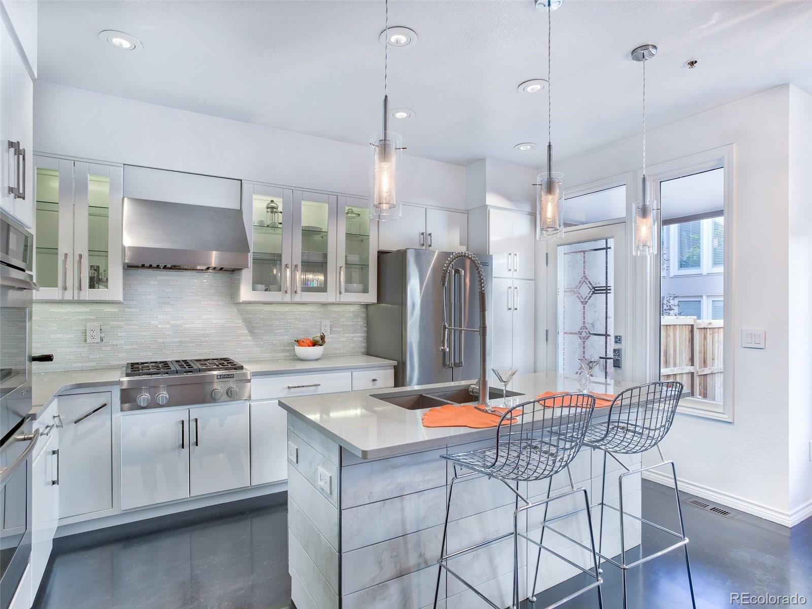 13 South Garfield Street Denver, CO 80209 - Photo 6 of 27 a kitchen with stainless steel appliances granite countertop a sink a stove a refrigerator and island