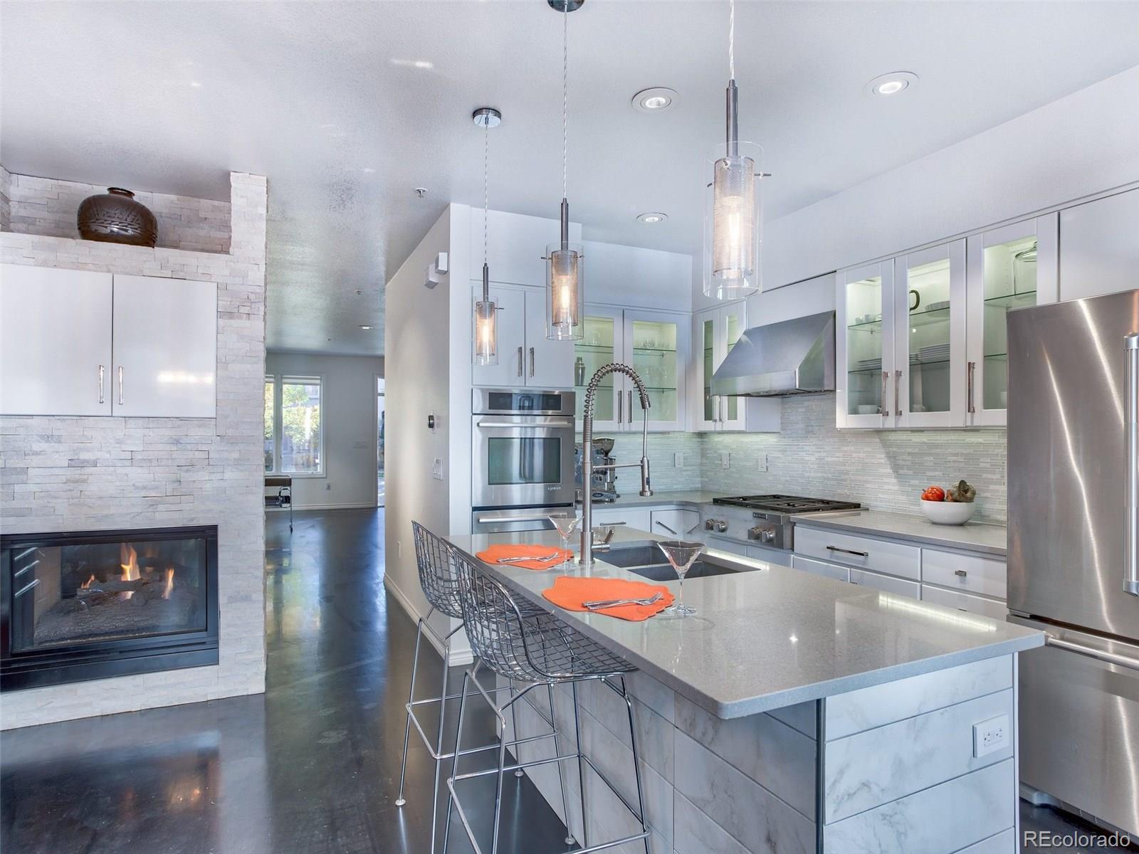 13 South Garfield Street Denver, CO 80209 - Photo 7 of 27 a kitchen with stainless steel appliances granite countertop a sink a stove and a refrigerator
