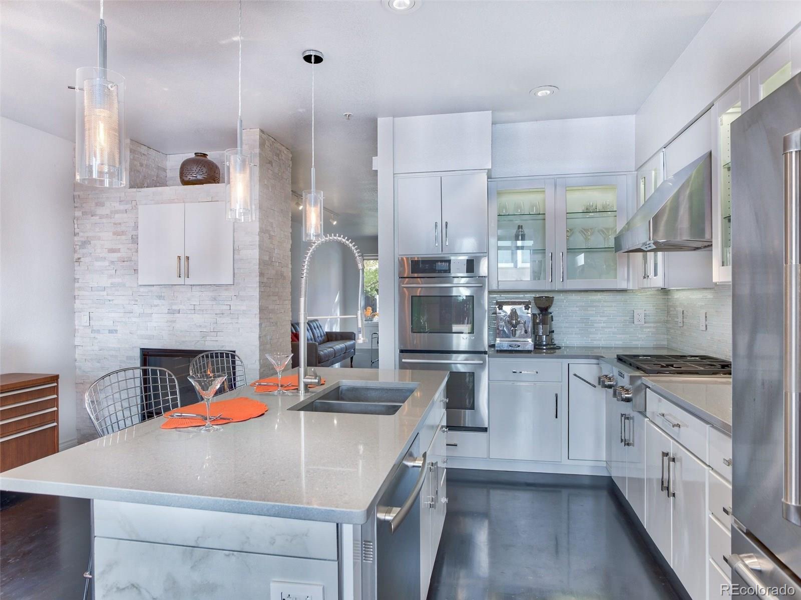 13 South Garfield Street Denver, CO 80209 - Photo 9 of 27 a kitchen with stainless steel appliances granite countertop a sink stove and refrigerator