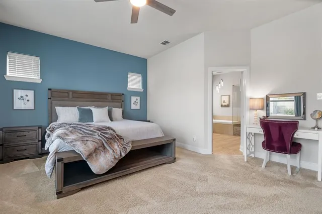 a bedroom with a bed and a dresser in it