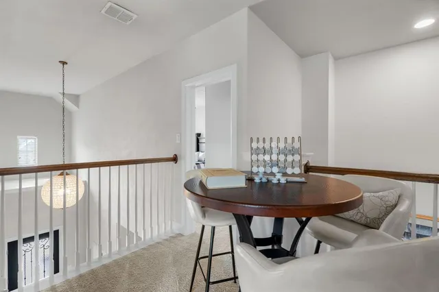 a bedroom with bed and a chandelier