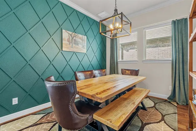 a view of a dining room with furniture and a window
