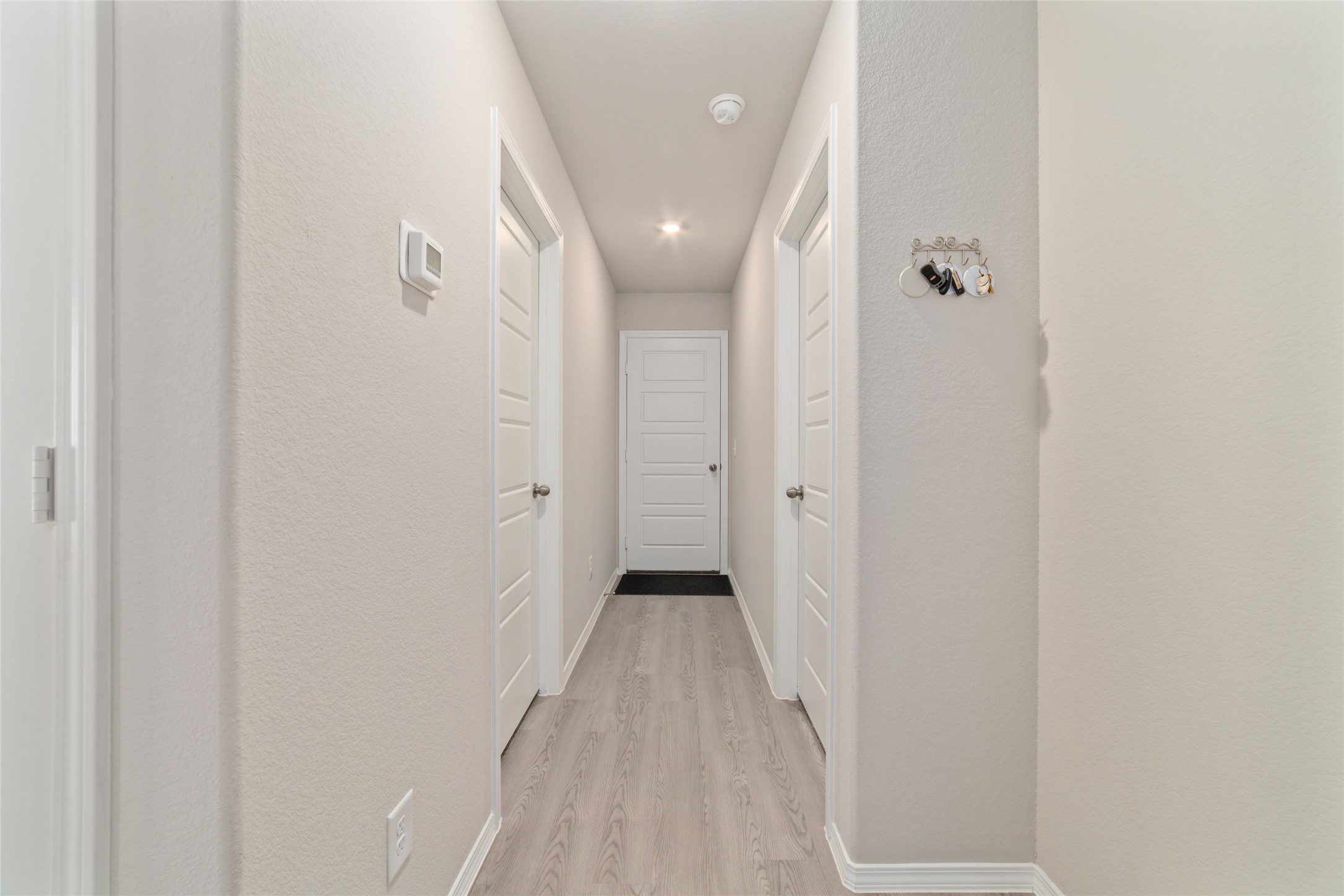 14232 Shasta Ridge Drive Conroe, TX 77303 - Photo 21 of 26 Bright hallway with high ceilings and recessed lighting, offering a clean, open feel that flows effortlessly to the rest of the home.