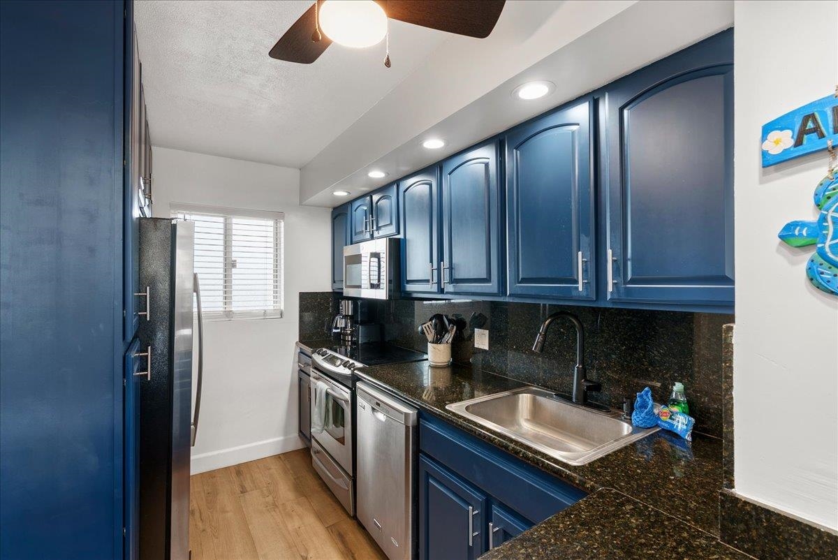 760 South Kihei Road, Unit 405 Kihei, HI 96753 - Photo 11 of 39 a kitchen with granite countertop a sink stove and cabinets