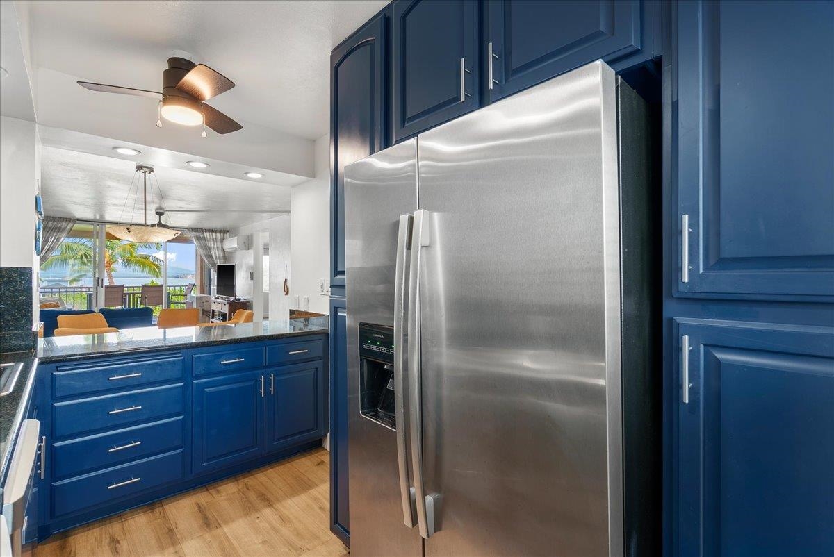 760 South Kihei Road, Unit 405 Kihei, HI 96753 - Photo 14 of 39 a kitchen with a refrigerator and cabinets
