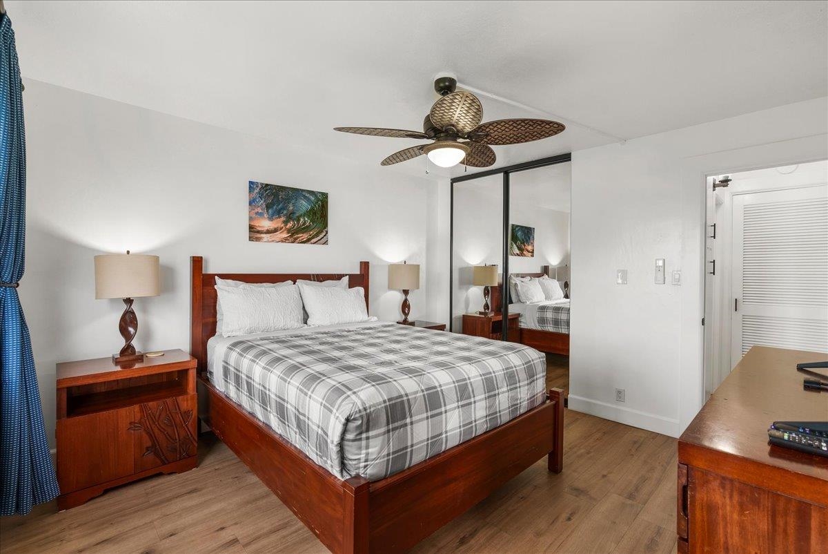 760 South Kihei Road, Unit 405 Kihei, HI 96753 - Photo 18 of 39 a bedroom with a bed and wooden floor