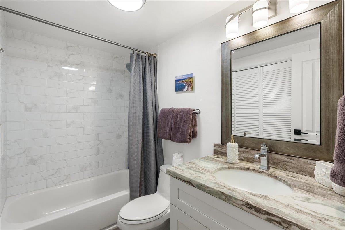 760 South Kihei Road, Unit 405 Kihei, HI 96753 - Photo 20 of 39 a bathroom with a granite countertop sink toilet and shower