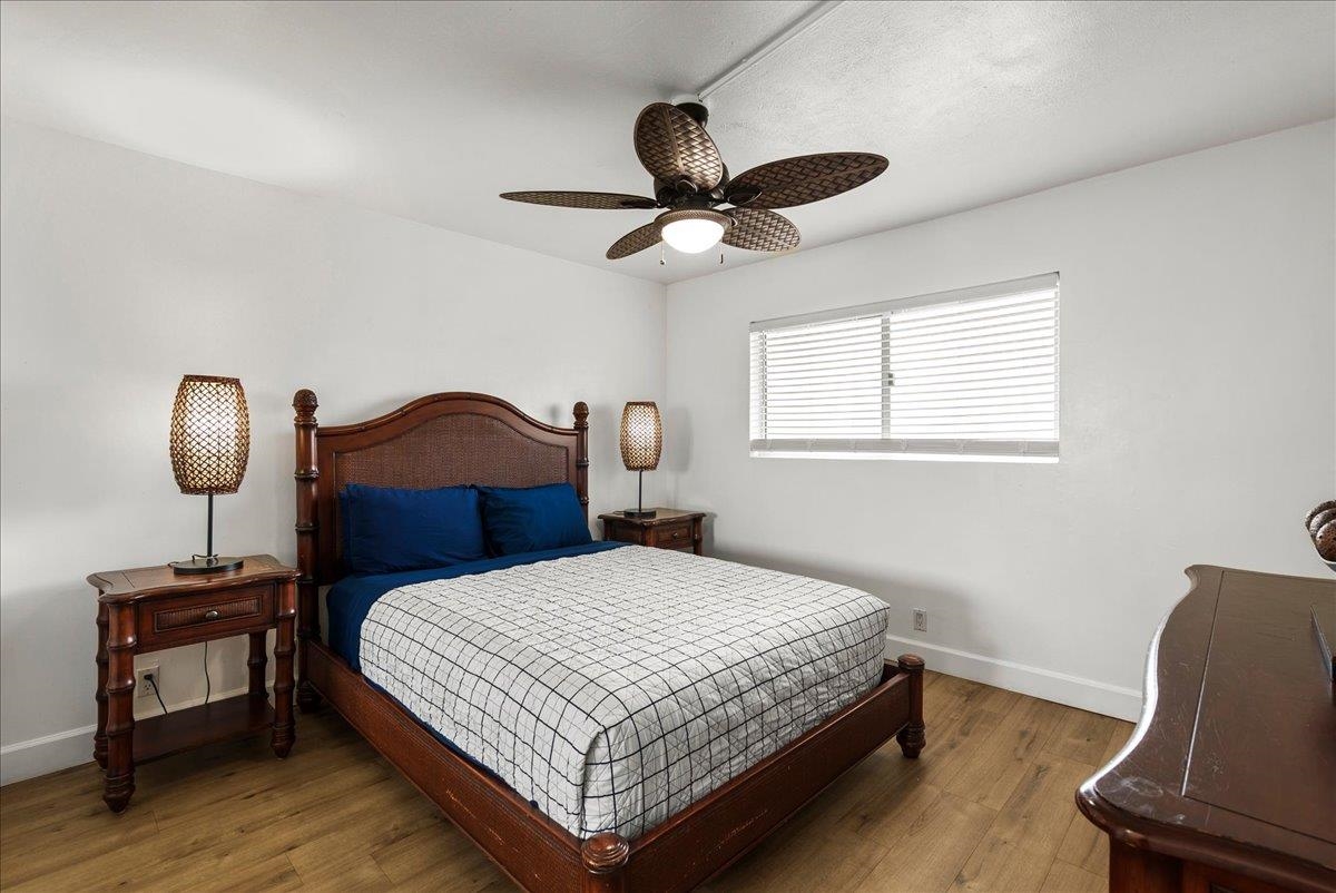 760 South Kihei Road, Unit 405 Kihei, HI 96753 - Photo 25 of 39 a bedroom with a bed wooden floor and a window