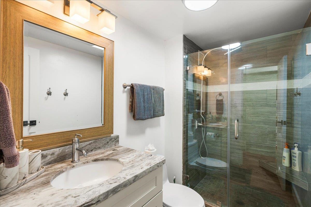 760 South Kihei Road, Unit 405 Kihei, HI 96753 - Photo 28 of 39 a bathroom with a granite countertop sink toilet and shower