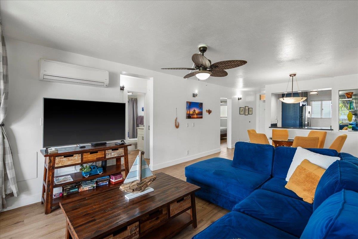 760 South Kihei Road, Unit 405 Kihei, HI 96753 - Photo 3 of 39 a living room with furniture and a flat screen tv