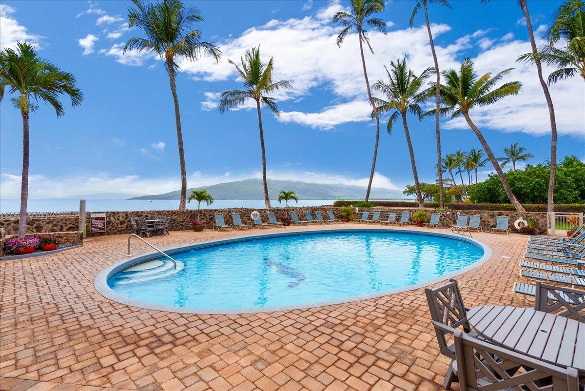 760 South Kihei Road, Unit 405 Kihei, HI 96753 - Photo 38 of 39 a view of a swimming pool with a table and chairs