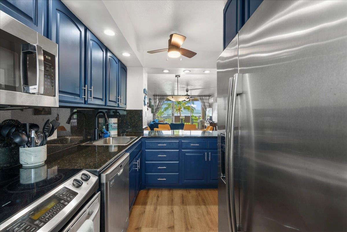 760 South Kihei Road, Unit 405 Kihei, HI 96753 - Photo 5 of 39 a kitchen with stainless steel appliances granite countertop a refrigerator and a stove