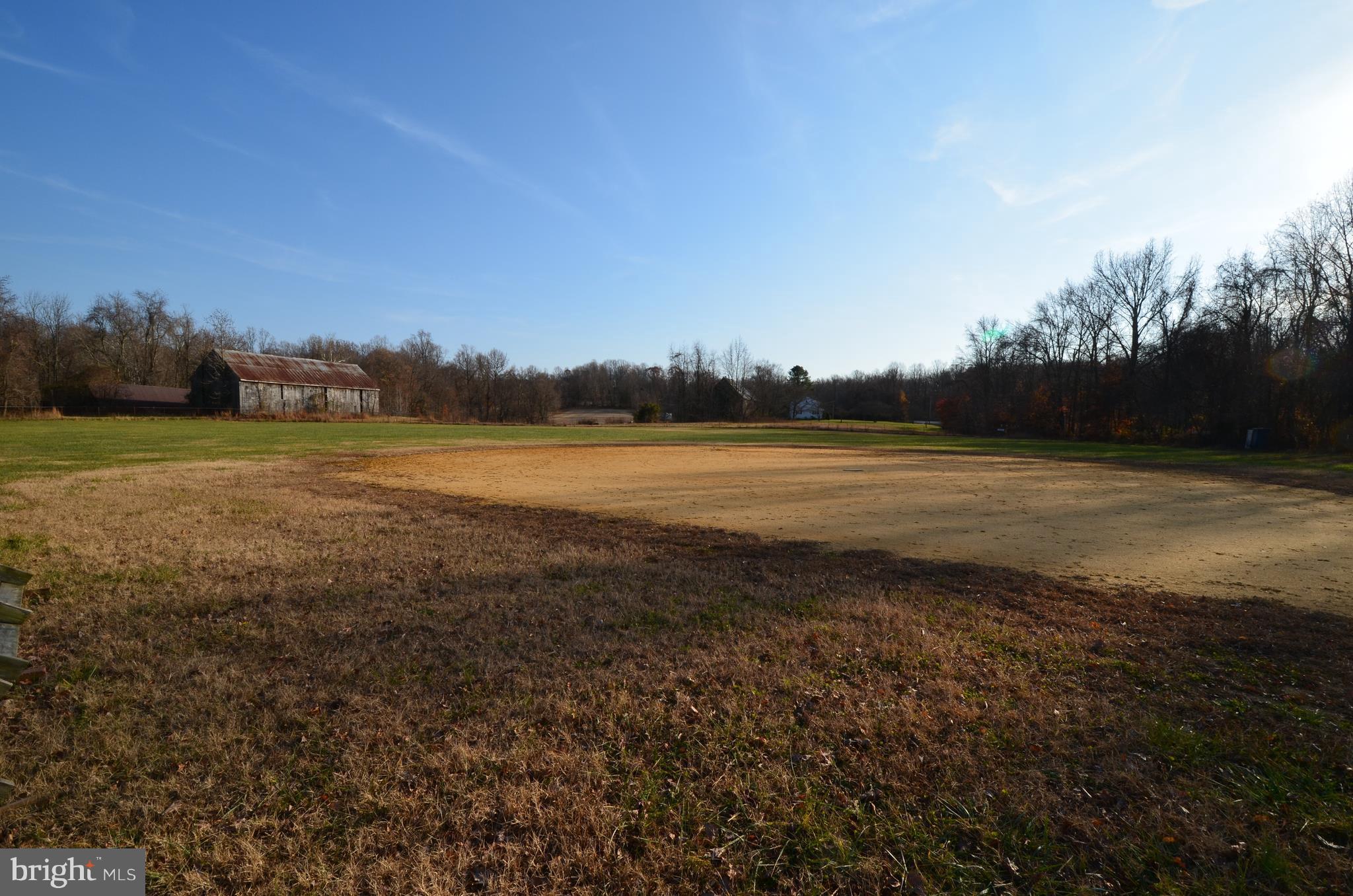 6095 Solomons Island Road Tracys Landing, MD 20779 - Photo 3 of 9 a view of an ocean beach and a yard