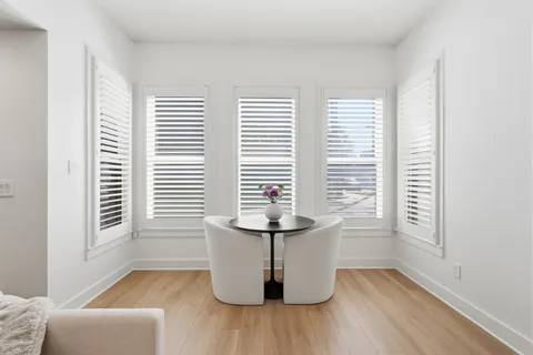 a view of a room with wooden floor and a window