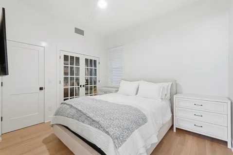 a bedroom with a bed and a window