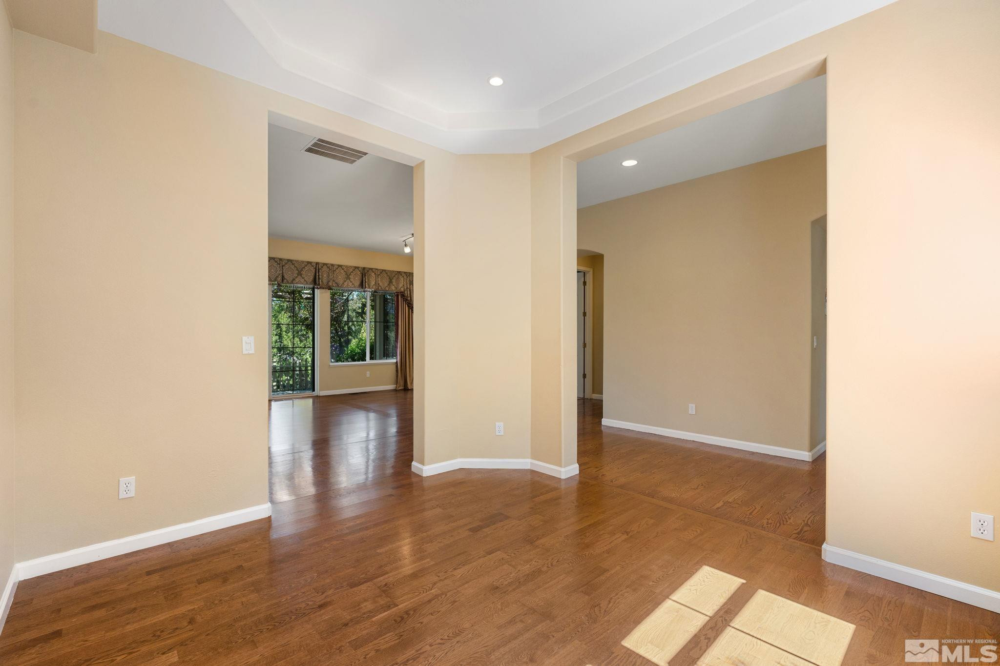 1745 Hunter Creek Road Reno, NV 89519 - Photo 11 of 40 a view of an empty room with wooden floor and a window