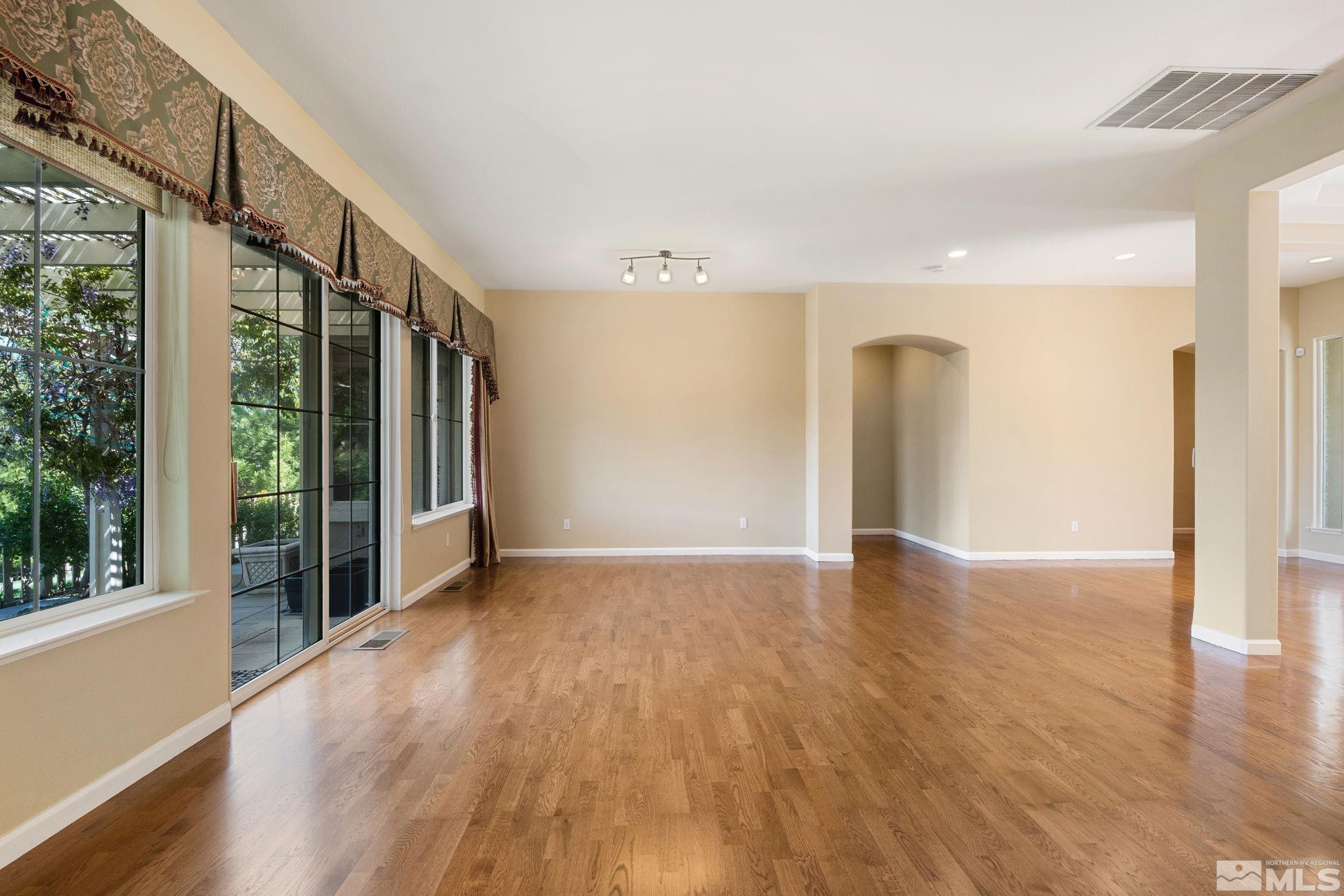1745 Hunter Creek Road Reno, NV 89519 - Photo 13 of 40 a view of an empty room with wooden floor and a window
