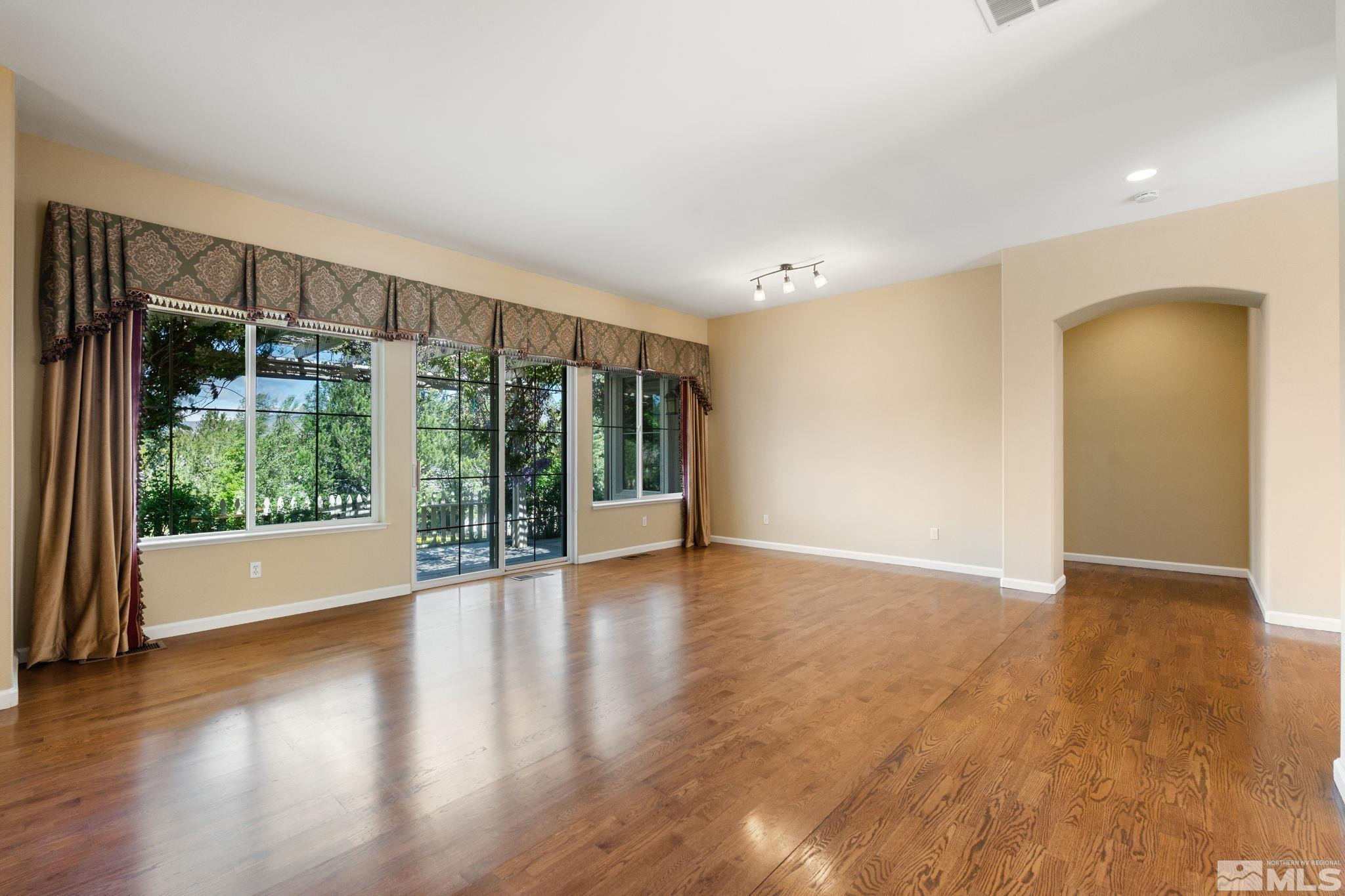 1745 Hunter Creek Road Reno, NV 89519 - Photo 14 of 40 a view of an empty room with wooden floor and a window
