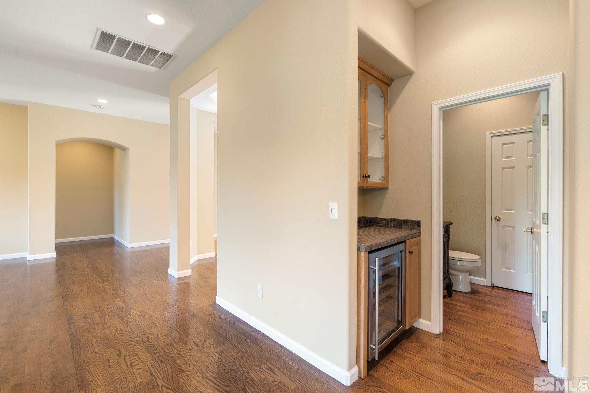 1745 Hunter Creek Road Reno, NV 89519 - Photo 15 of 40 a view of a hallway with wooden floor and a bathroom