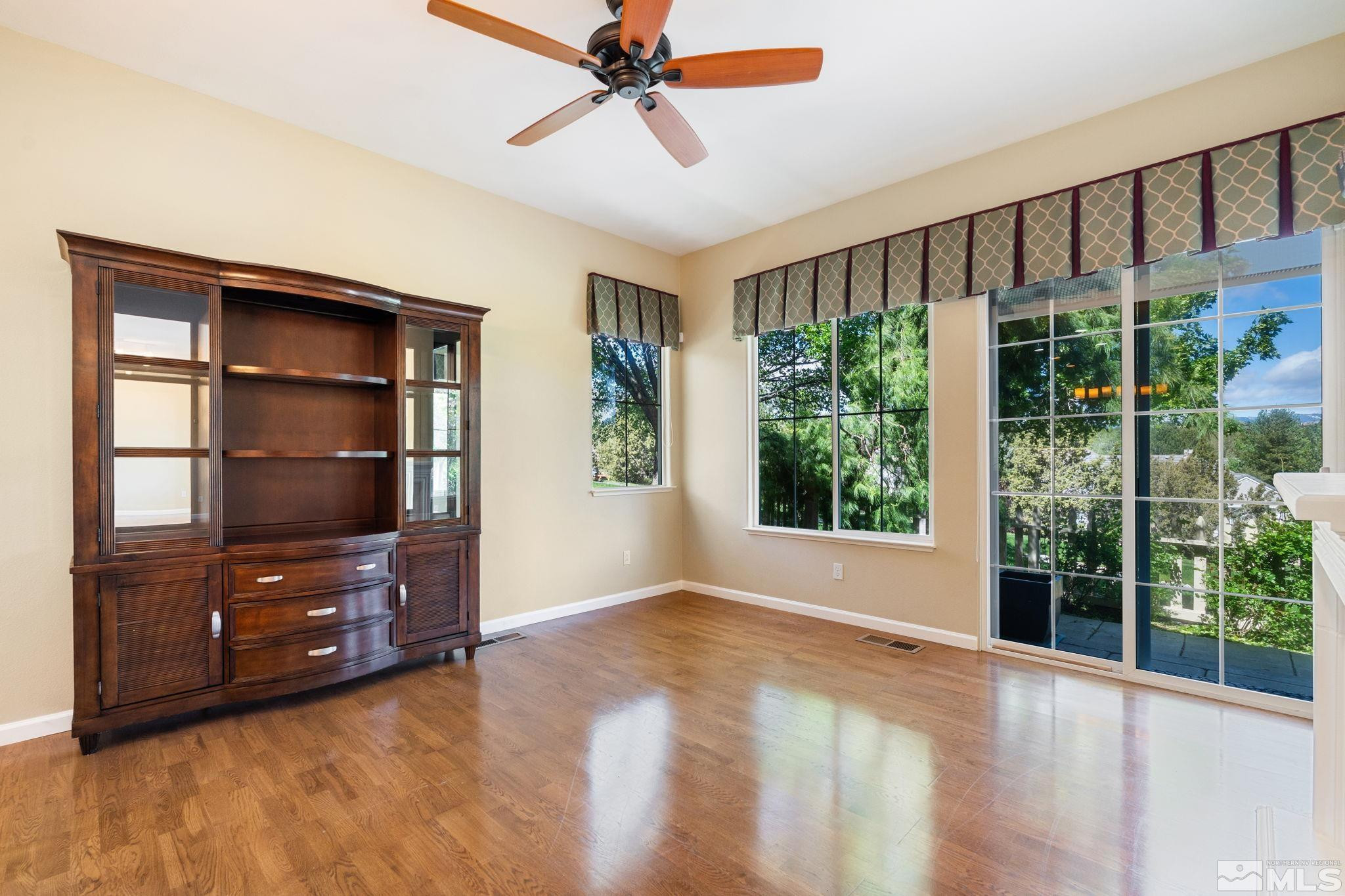1745 Hunter Creek Road Reno, NV 89519 - Photo 19 of 40 a view of an empty room with a window and wooden floor