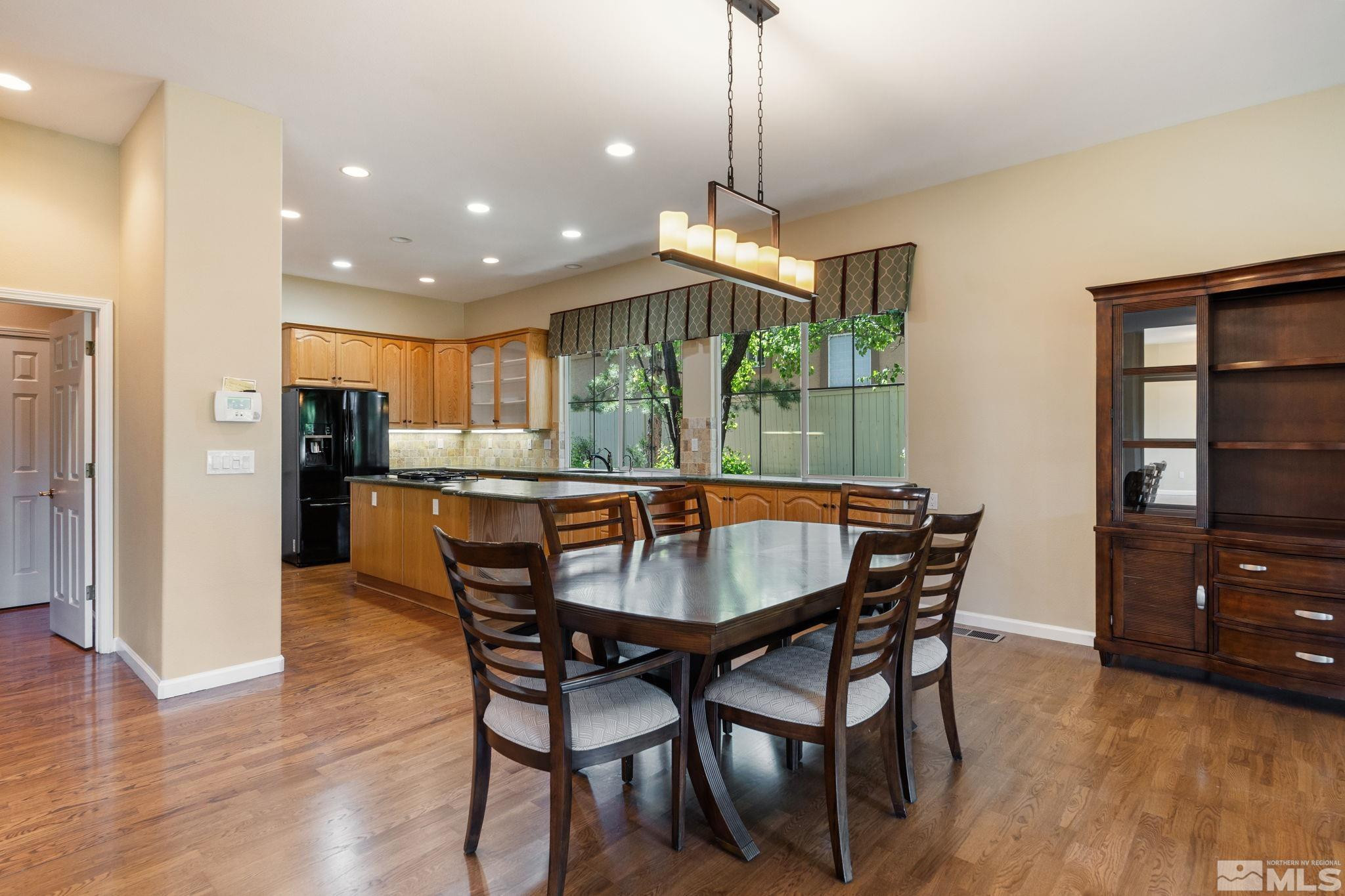 1745 Hunter Creek Road Reno, NV 89519 - Photo 21 of 40 a view of a dining room with furniture window and wooden floor