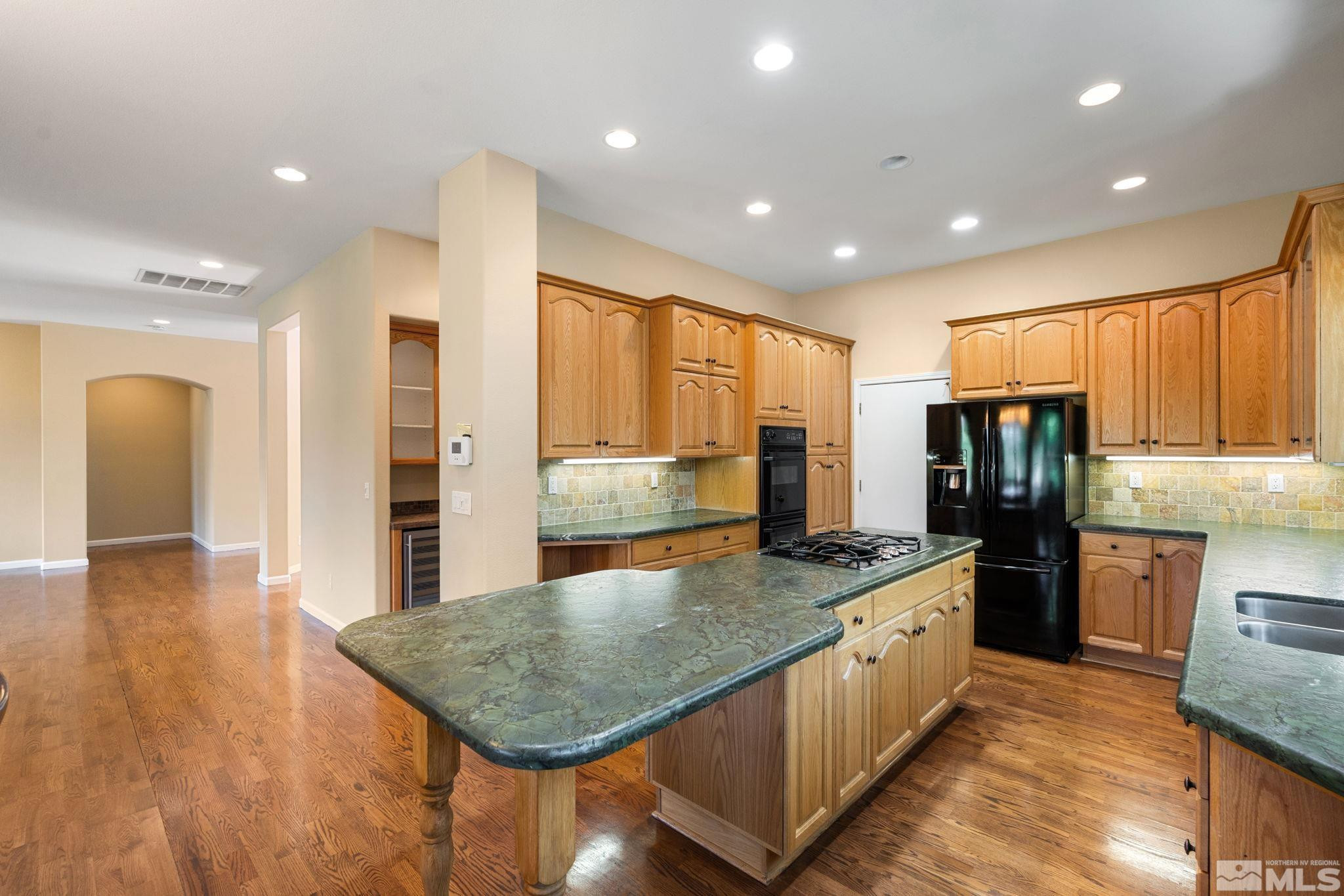1745 Hunter Creek Road Reno, NV 89519 - Photo 24 of 40 a kitchen with stainless steel appliances granite countertop a refrigerator a sink a stove and oven