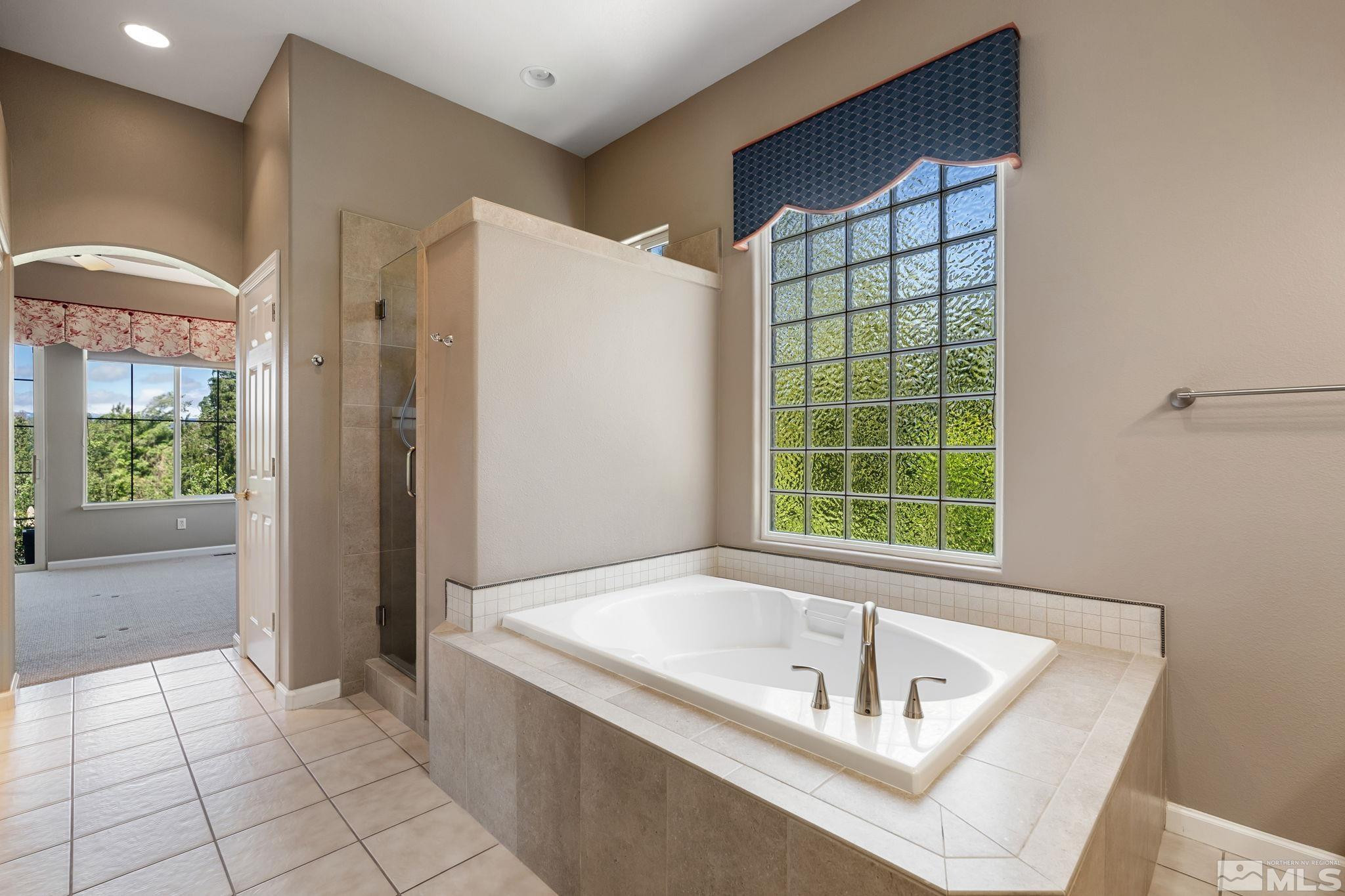 1745 Hunter Creek Road Reno, NV 89519 - Photo 30 of 40 a bath tub sitting in a bathroom next to a window