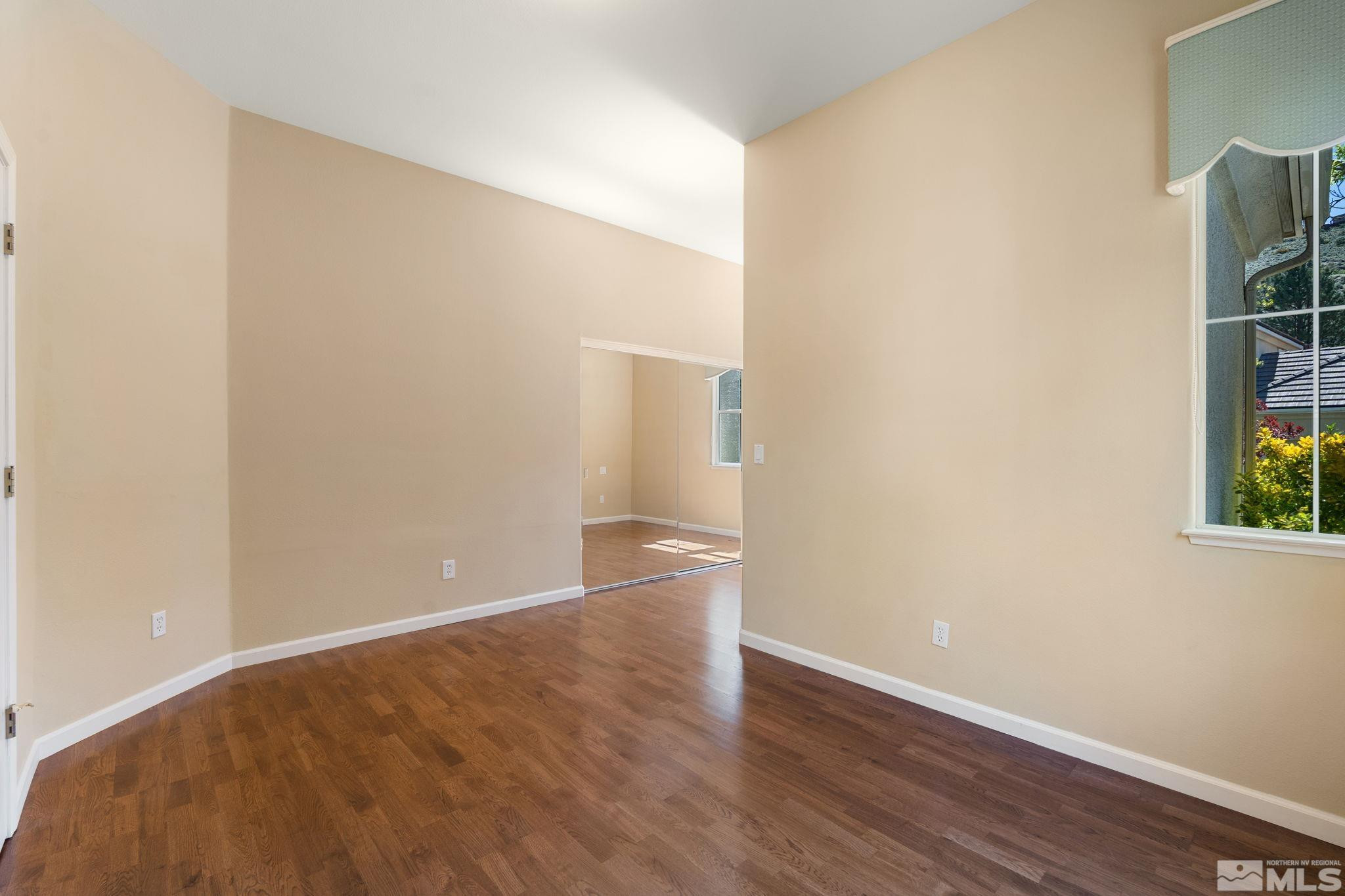 1745 Hunter Creek Road Reno, NV 89519 - Photo 32 of 40 a view of an empty room with wooden floor and a window