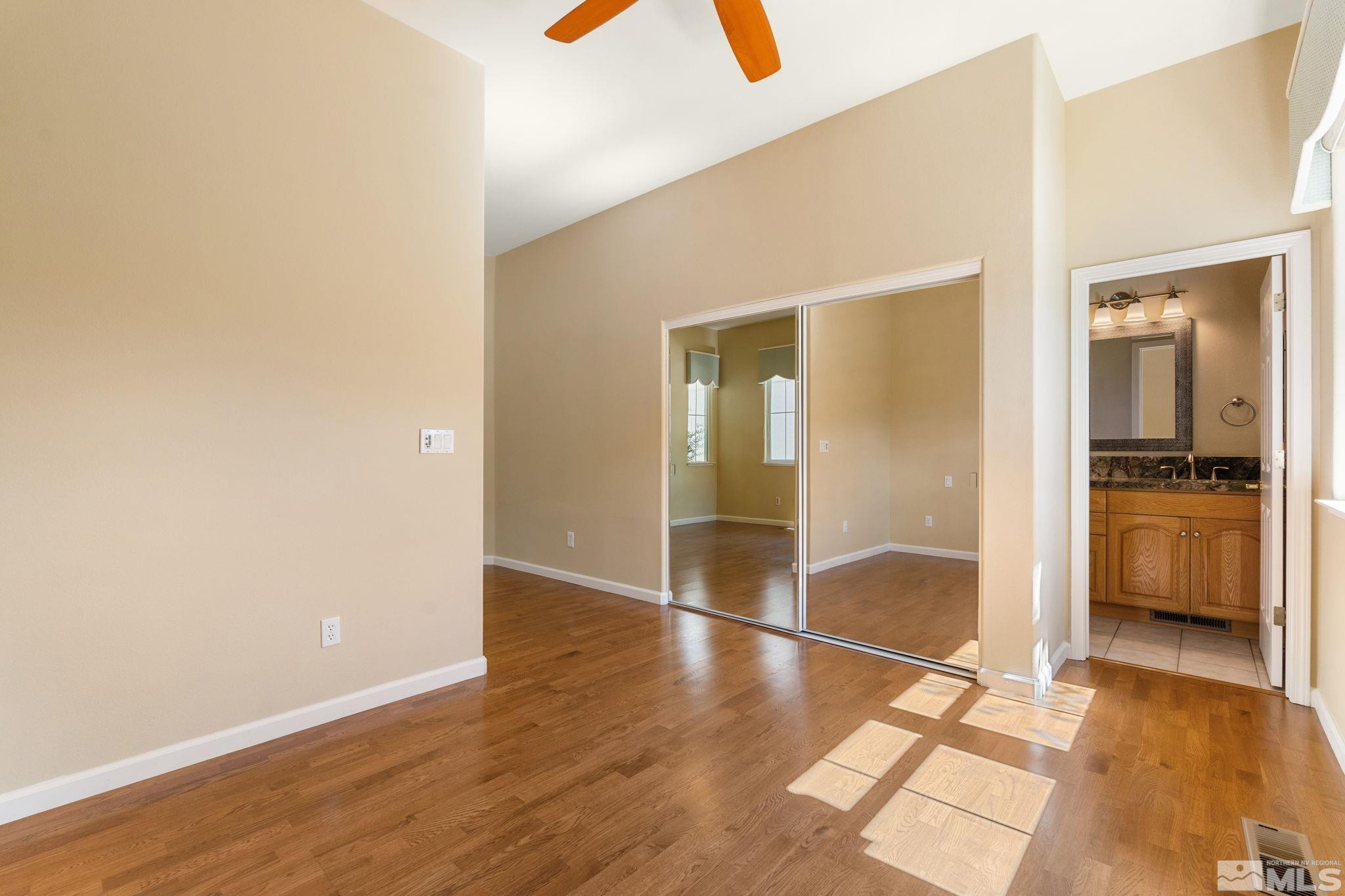 1745 Hunter Creek Road Reno, NV 89519 - Photo 33 of 40 an empty room with wooden floor and a bathroom